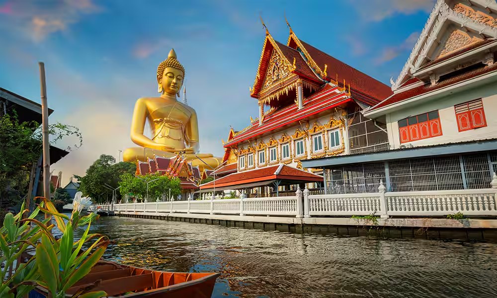 Golden Buddha statue beside a Thai temple